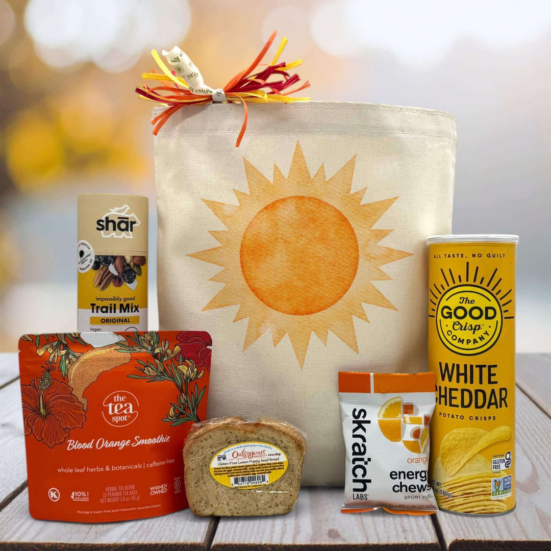 Sun-themed gift  package with snacks, tea, and tote bag