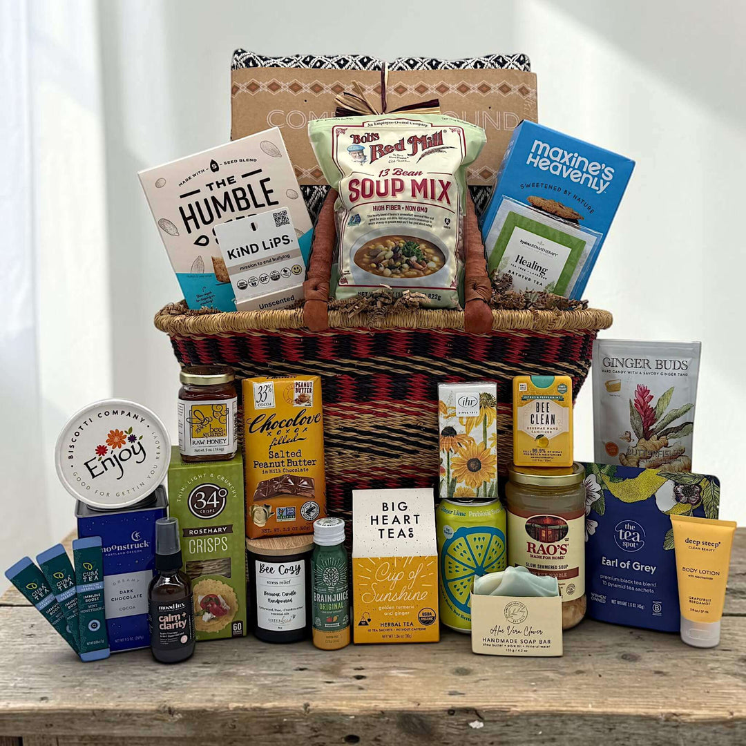 african market gift basket with blanket and a variety of get well items like soups, drinks, spa comforting items