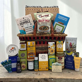 african market gift basket with blanket and a variety of get well items like soups, drinks, spa comforting items