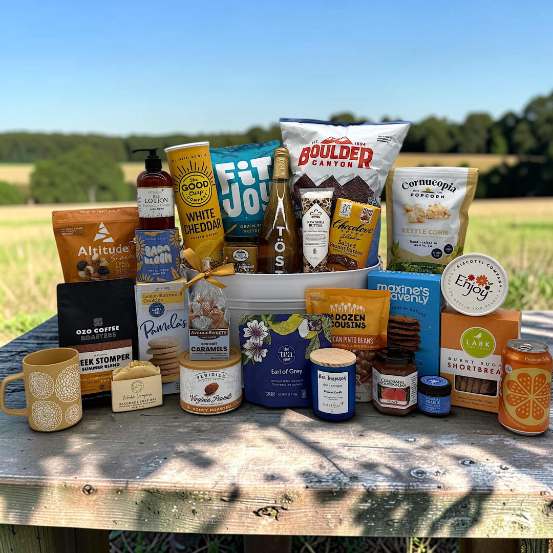 white tin tub filled with a large variety of snacks and spa items