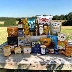 white tin tub filled with a large variety of snacks and spa items