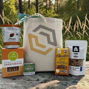 tote basket with peanuts, cookies, mints, chocoalte bar, and granola