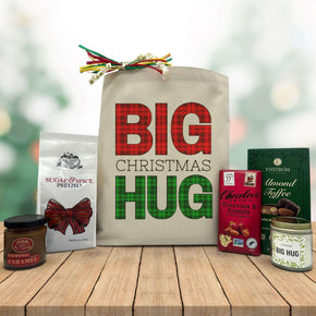 big christmas hug with pretzels and caramel, chocolate bar, almond toffee and a candle