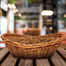 large light wicker basket filled with sizzle and sitting on a table
