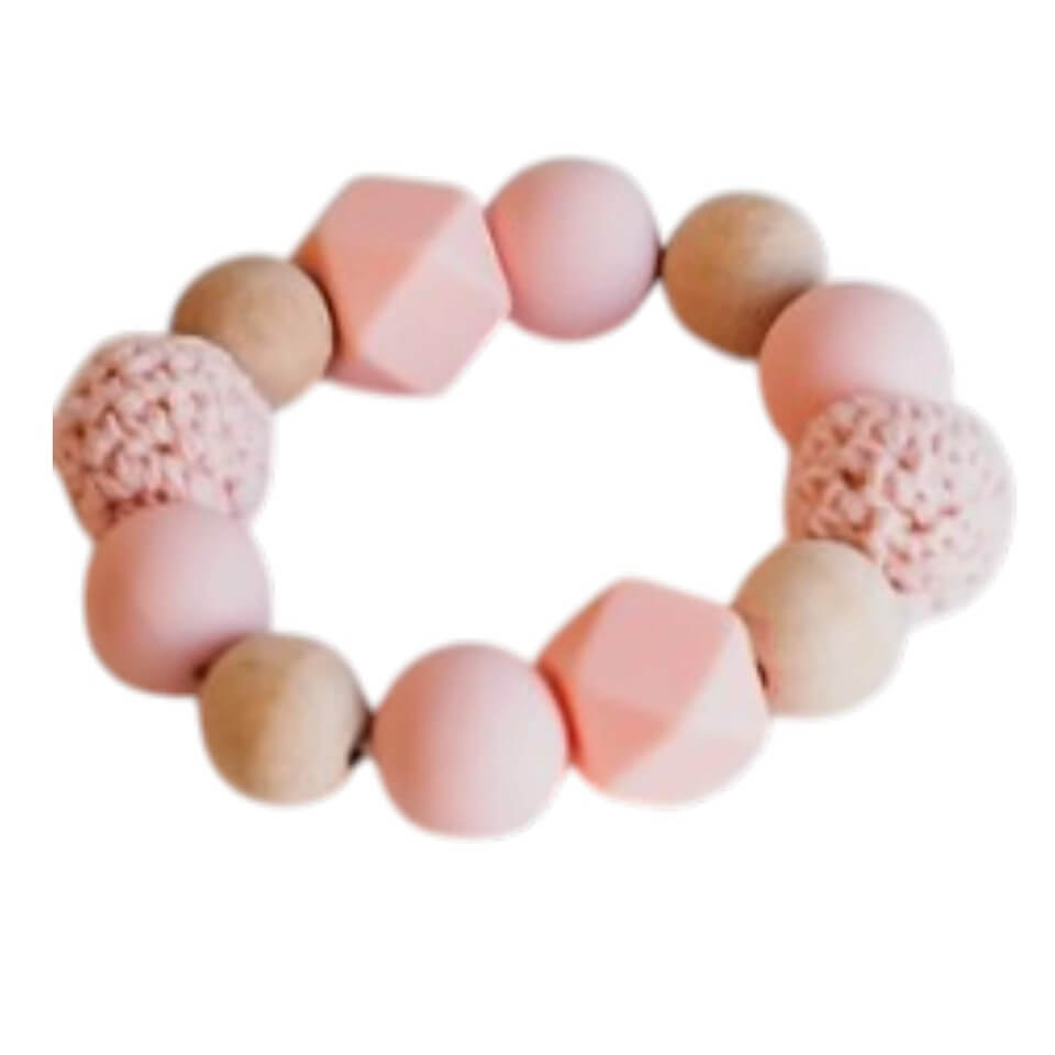 teething ring in pink made of wood and knitted beads