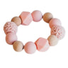 teething ring in pink made of wood and knitted beads