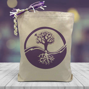 A Purple Ying Yang Tree Design upper half shows leafy branches and lower half shows exposed roots, placed on a wooden table purple background 