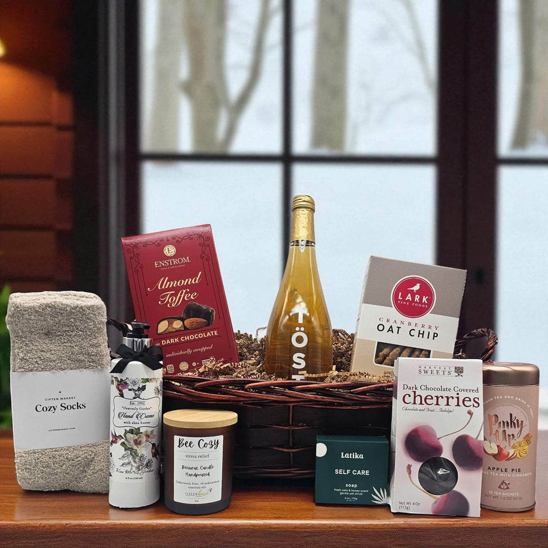 gourmet holiday gift basket with almond toffee, sparkling juice, cookies, socks, lotion, a candle, soap, cherries and tea