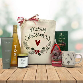 Gourmet christmas gift with lotion, sparking juice, a large candle, peppermint caramels, almond toffee and a mug