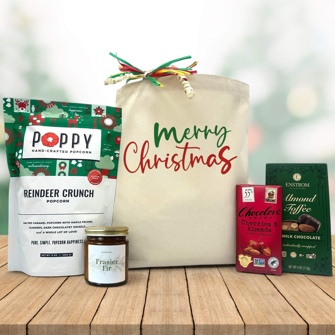 Gourmet holiday gift basket with popcorn, a candle, chocoalte bar and almond toffee