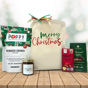 Gourmet holiday gift basket with popcorn, a candle, chocoalte bar and almond toffee