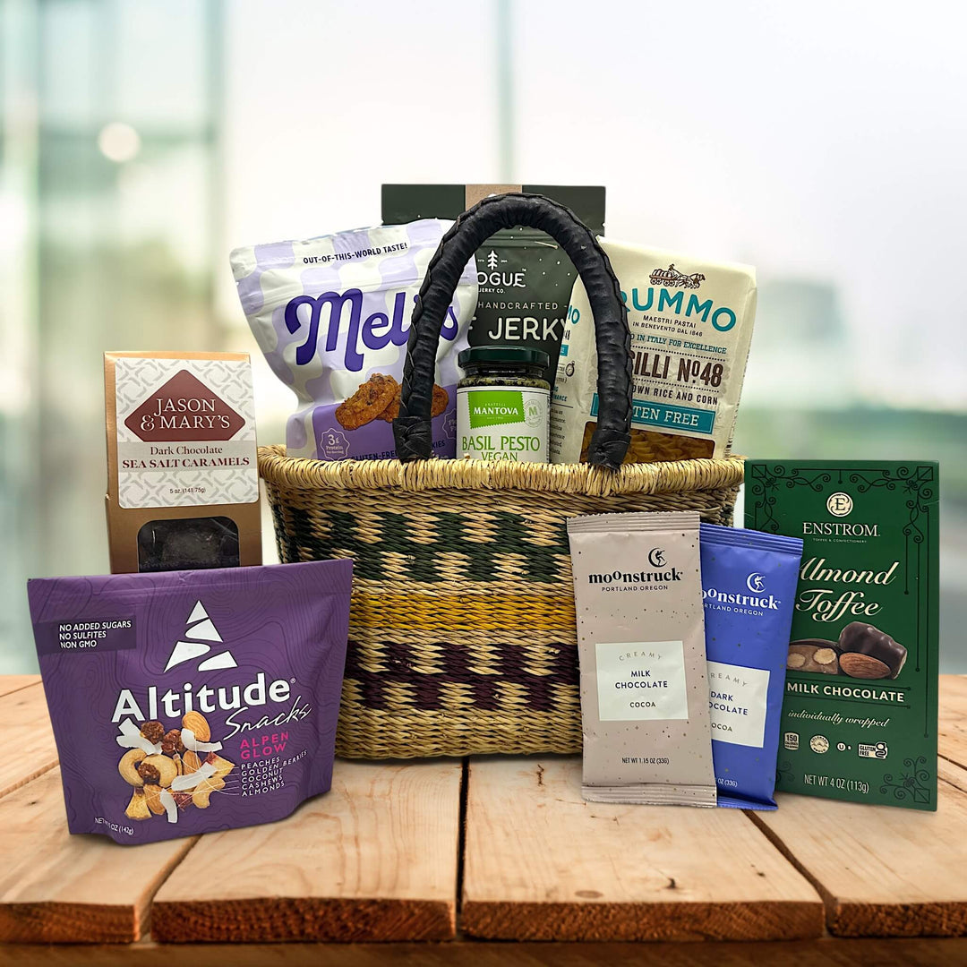 handwoven basket with cookies, jerkys, pasta, pesto, caramels, trailmix, almond toffee and cocoa