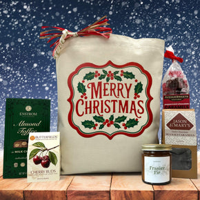 Gourmet holiday gift basket with almond toffee, cherry buds, a candle, dark sea salt caramels and peppermint caramels