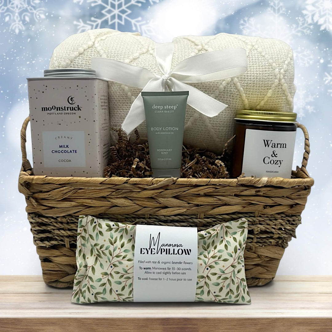 gourmet holiday gift basket with a blanket, cocoa, lotion, a large candle and an eye pillow