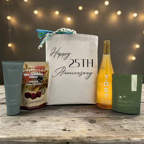 Gourmet anniversary gift basket with lotion, caramels, sparkling juice, and bath salts