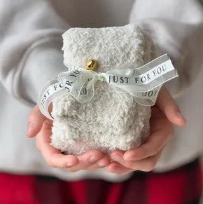 Cozy Socks wrapped in a branded Just for You Ribbon with a Jingle Bell