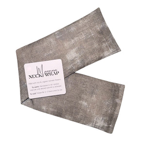 Grey neckwrap filled with lavender and rice laying on table with manorosa branded tag