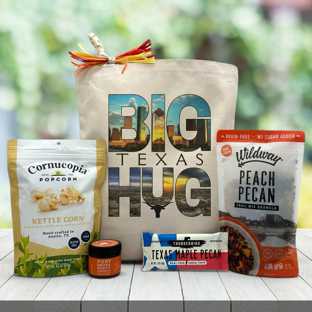 big texas hug with city skyline and longhorn printed on canvas tote bag with popcorn, honey, bar and granola