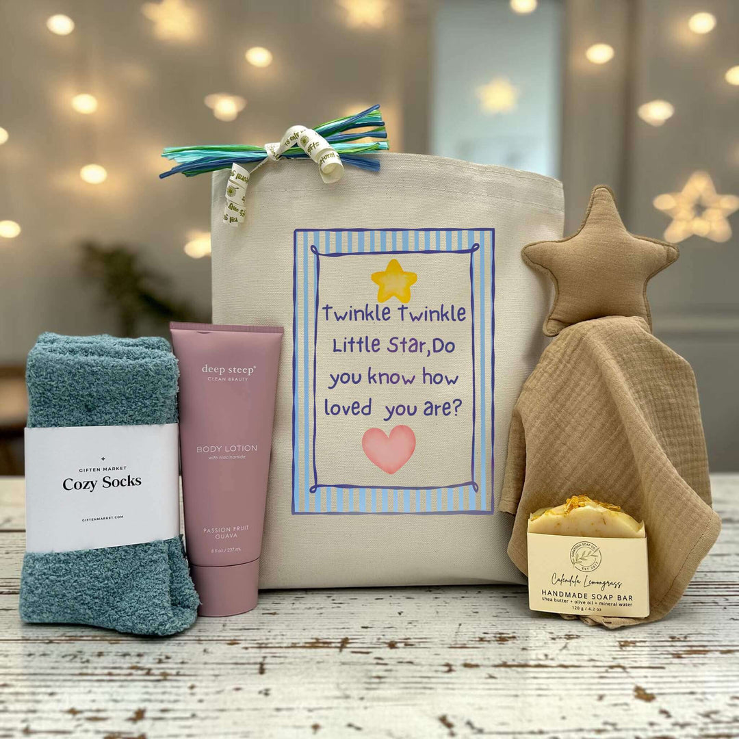 tote with blue socks, lotion, soap bar and lovey sitting on table