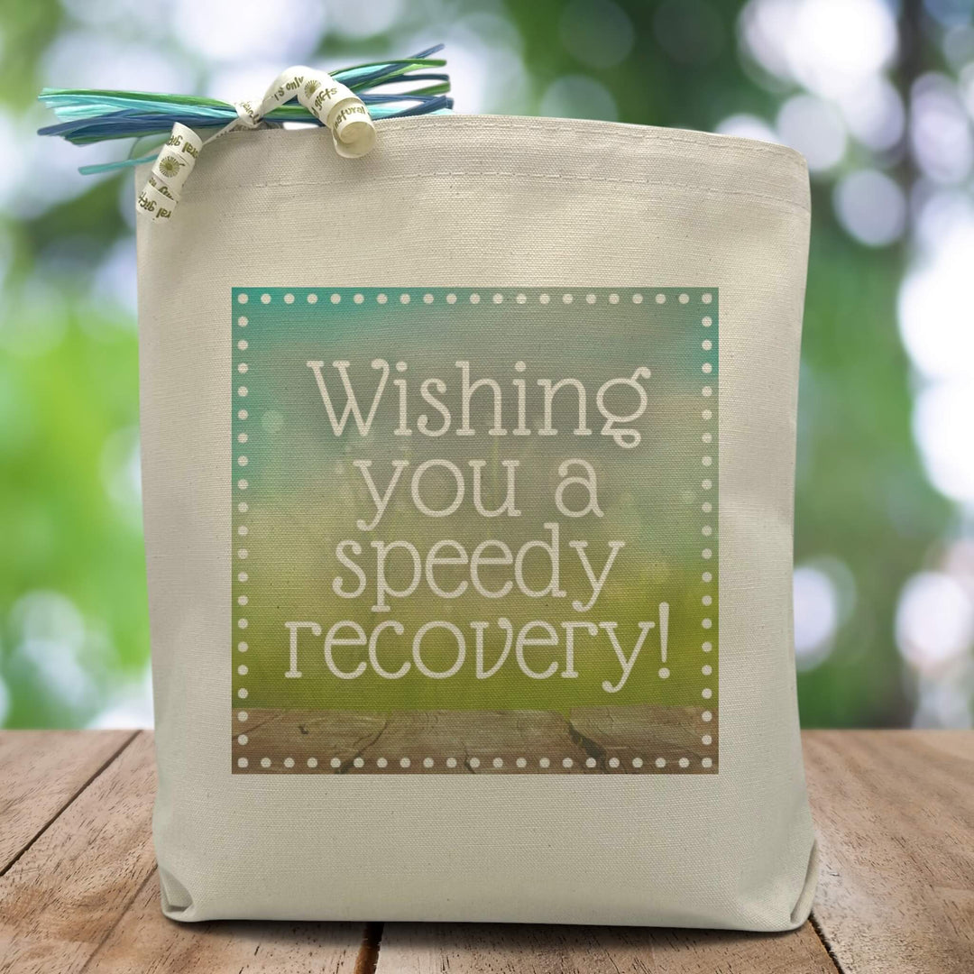 a blue and green box with the text wishing you a speedy recovery placed in the middle printed on a canvas tote bag. 