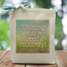 a blue and green box with the text wishing you a speedy recovery placed in the middle printed on a canvas tote bag. 
