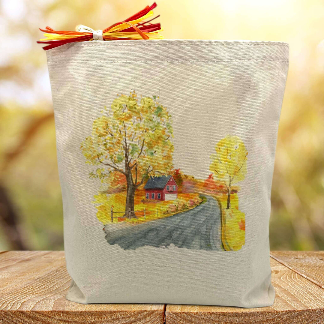 Yellow autumn nature theme printed on cavnas tote bag sitting on table with blurred fall background