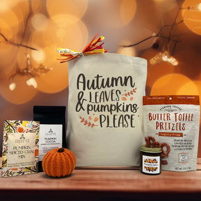 gourmet fall gift basket with pumpkin spiced chai mix, pumpkin cocoa, decor pumpkin, pumpkin spice candle, and toasted pecan toffee pretzels