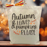 autumn leaves and pumpkin please printed on a canvas tote bag sitting on a table with a blurred background
