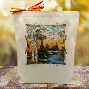autumn nature scene printed on a canvas tote bag sitting on a table