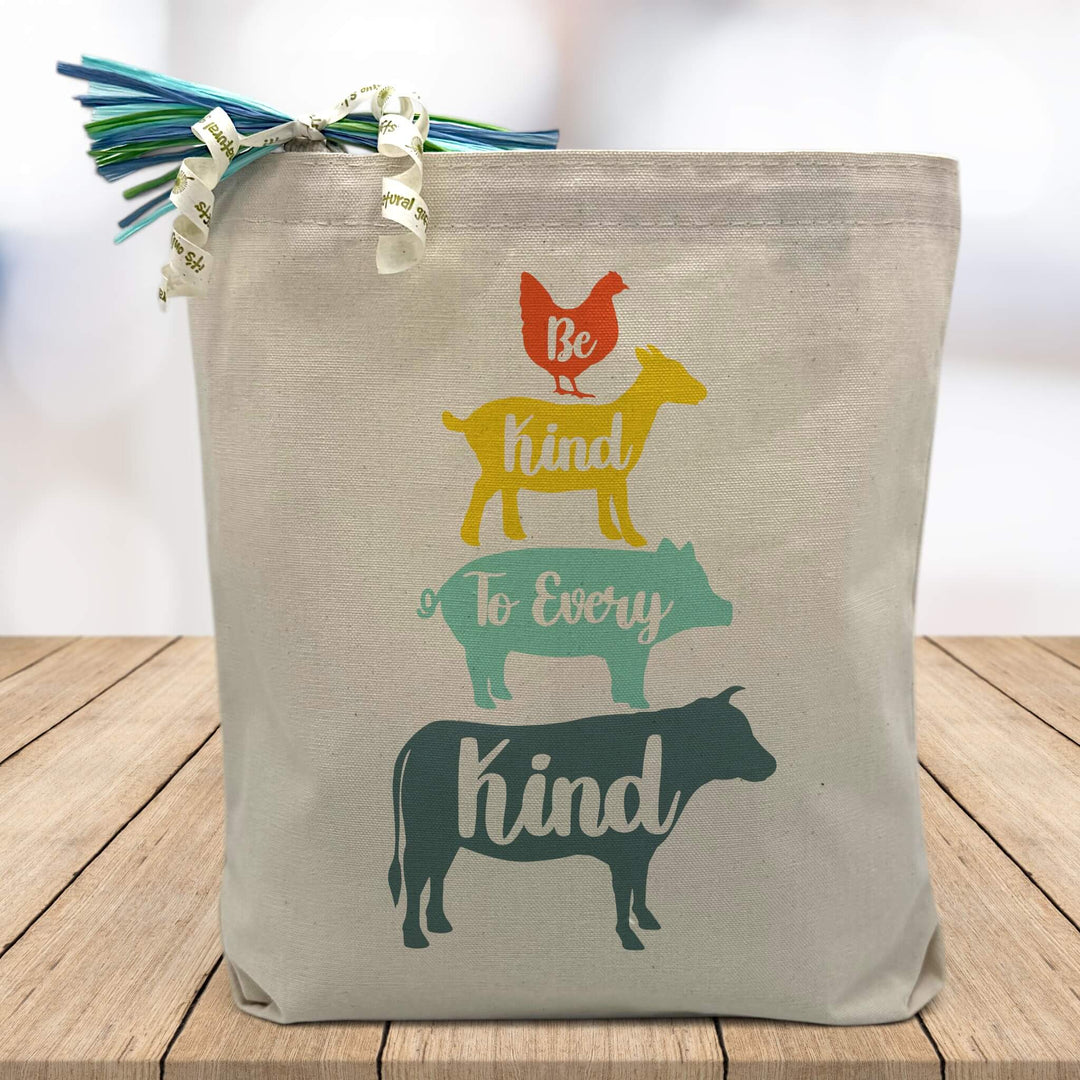 Be Kind to Every Kind with a blue cow, blue pig, yellow goat and orange chicken printed on canvas tote bag