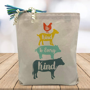 Be Kind to Every Kind with a blue cow, blue pig, yellow goat and orange chicken printed on canvas tote bag