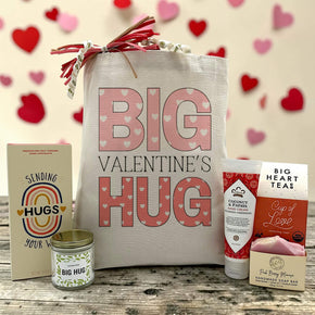 valentines gift with a chocolate bar, a candle, lotion, tea, and soap 