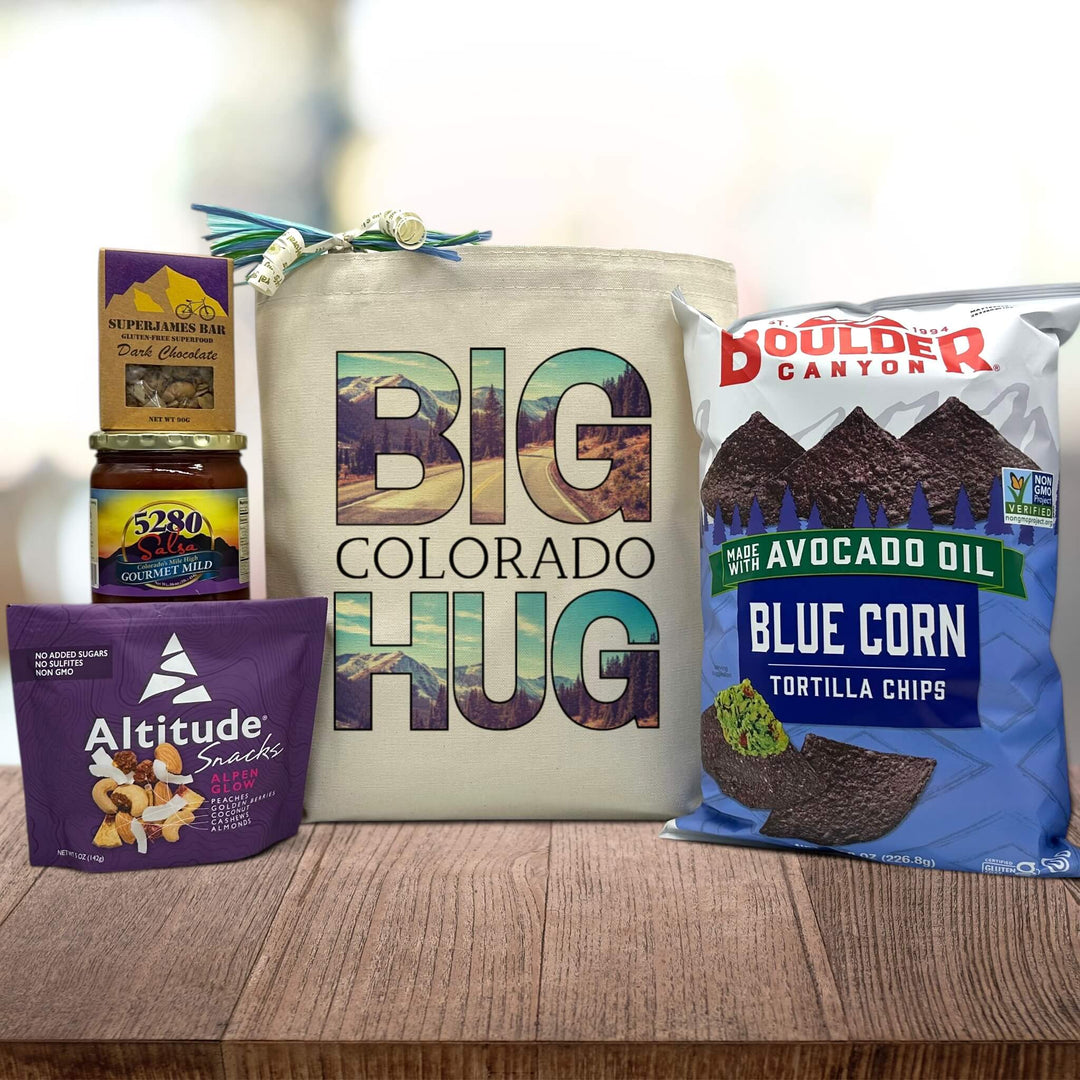 tote bag with design Big Colorado Hug with mountains printed, contains superjames bar, salsa, trial mix, and blue corn tortilla chips