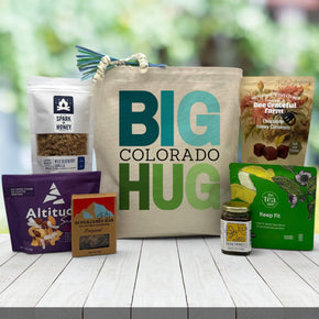 green and blue big colorado hug with granola, trail mix, bar, honey, tea and caramels