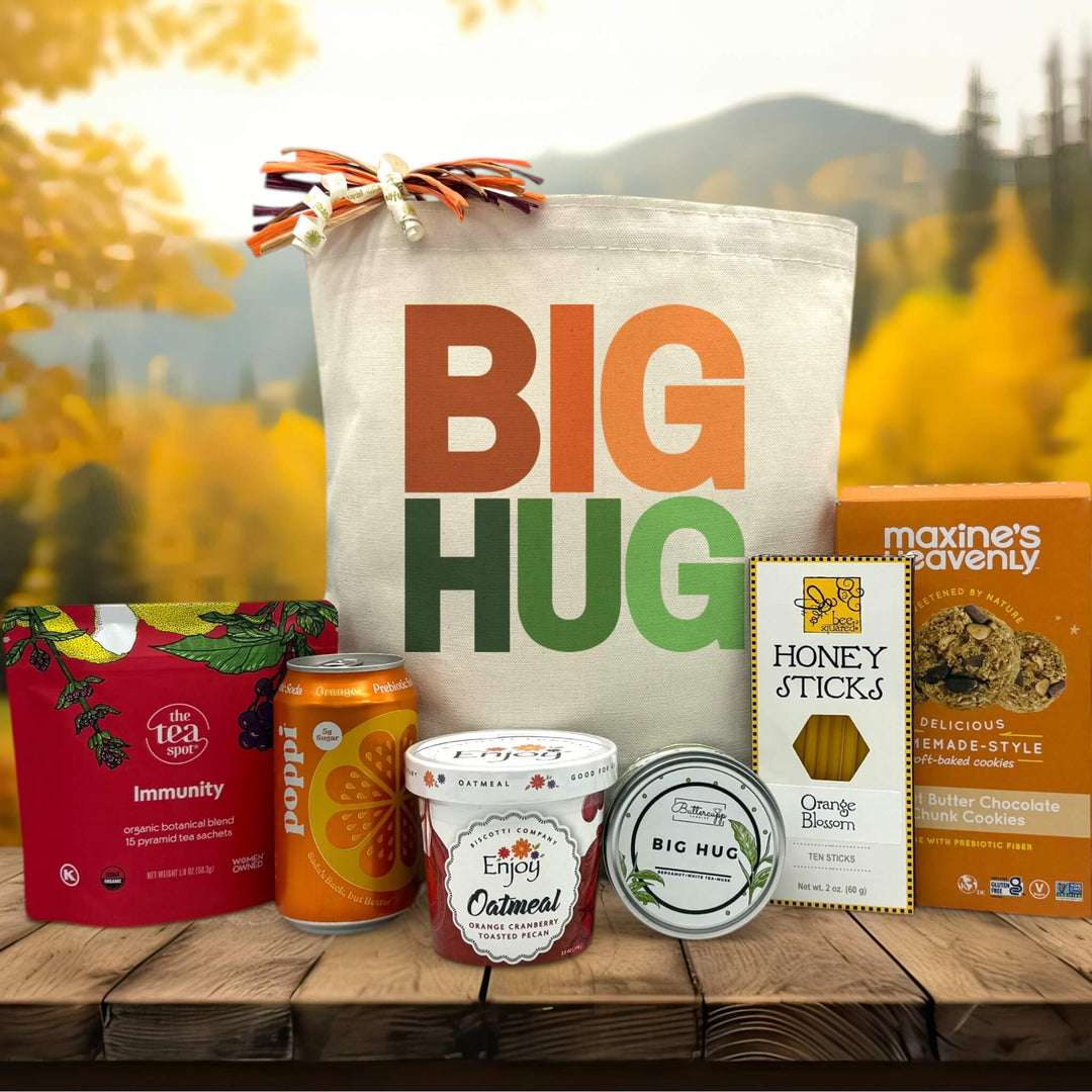 Orange and green Big Hug printed on canvas tote bag with tea, poppi, oatmeal, candle, honey and cookies