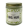 big hug candle with green leaves around