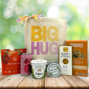Big hug in yellow and purple  with tea, poppi, oatmeal, a candle, honey sticks and cookies