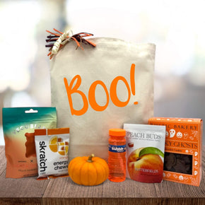 Gourmet halloween gift basket with gummy bears, energy chews, knit pumpkin, bubbles, peach buds, and cookies