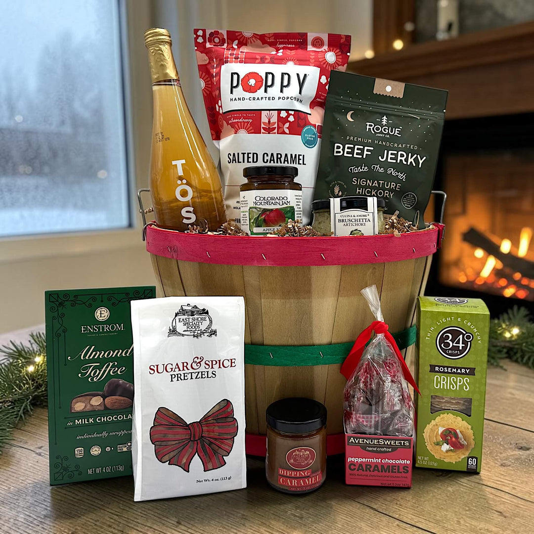 Gourmet holiday bushel basket with sparkling juice, popcorn, jerky jam, bruschetta and crackers, almond toffee, caramels and pretzels