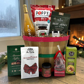 Gourmet holiday bushel basket with sparkling juice, popcorn, jerky jam, bruschetta and crackers, almond toffee, caramels and pretzels