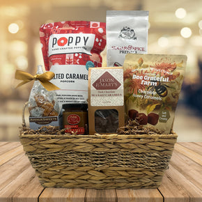 wicker gift basket with popcorn, pretzels and caramel, caramels, sea salt caramels, and honey caramels