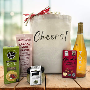new years cheers gift basket with crackers, salami, bruschetta, chocolate bar, and sparkling juice