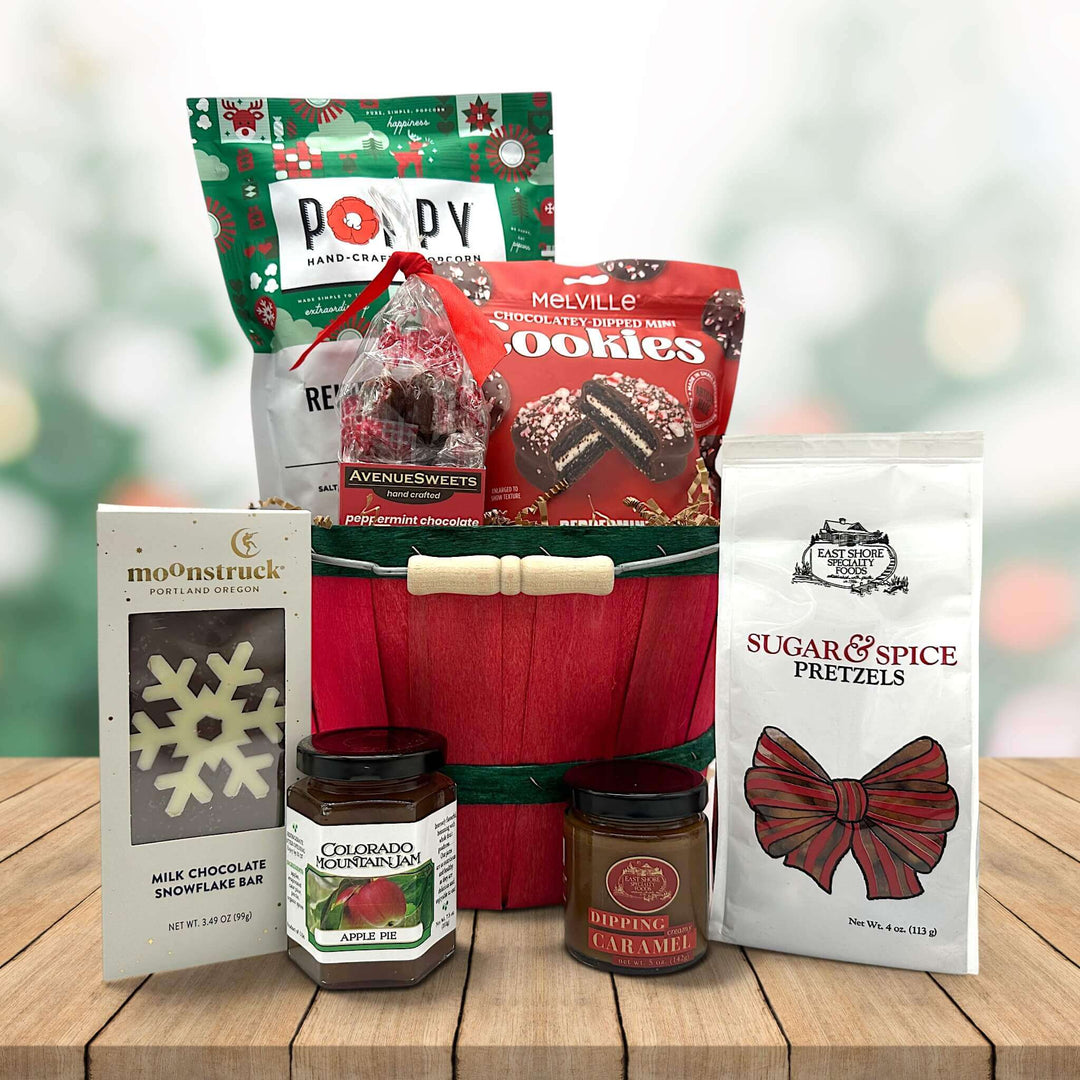 holiday bushel basket with popocorn, coookies, caramels, chocolate bar and pretzels and jam