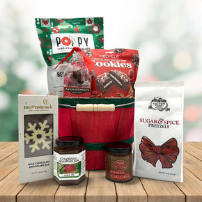 holiday bushel basket with popocorn, coookies, caramels, chocolate bar and pretzels and jam