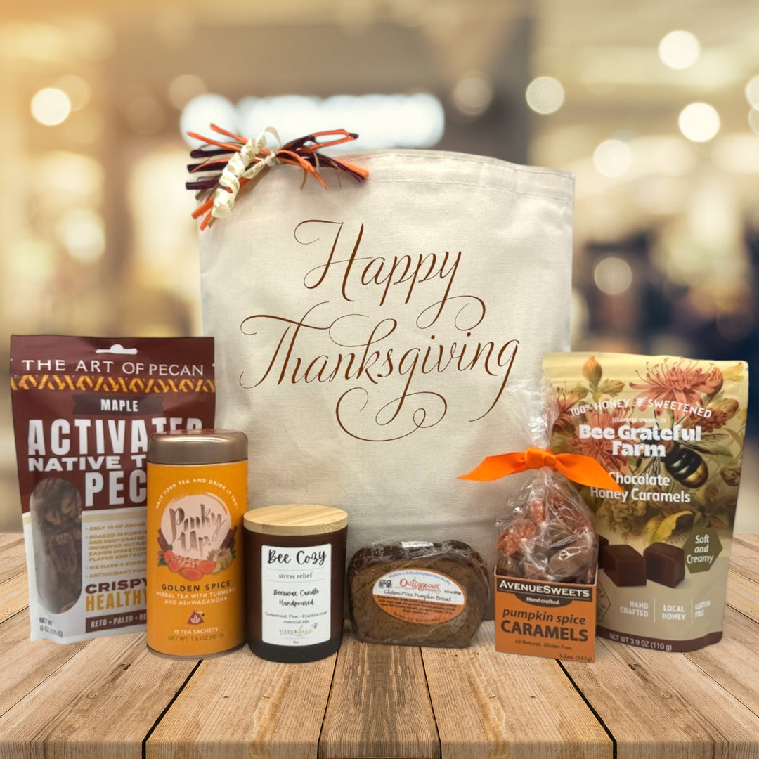 Gourmet thanksigivng gift basket with pecans, tea, candle, bread, caramels, and chocolate caramels