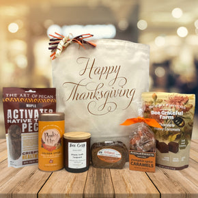 Gourmet thanksigivng gift basket with pecans, tea, candle, bread, caramels, and chocolate caramels