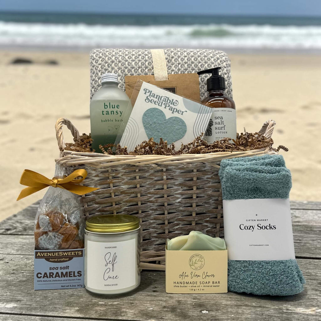 Wikcer basket filled with spa prodcuts sitting on a table at the beach