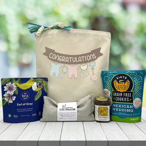 congratulations new baby banner with tea honey, eye pillow and cookies