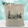 cozy cabin scene printed on a canvas tote bag sitting on a table with a blurred blue background