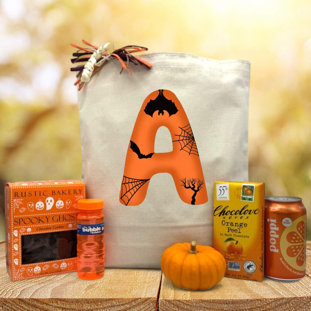 custom halloween letter gift basket with cookies, bubbles, knit pumpkin, chocolate bar and poppi